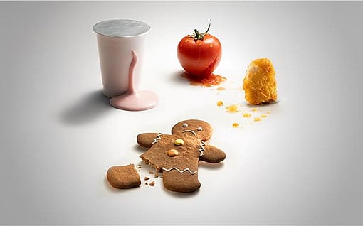 gingerbreadman with broken foot, tomato, spilled milkshake and chicken nugget on a white background